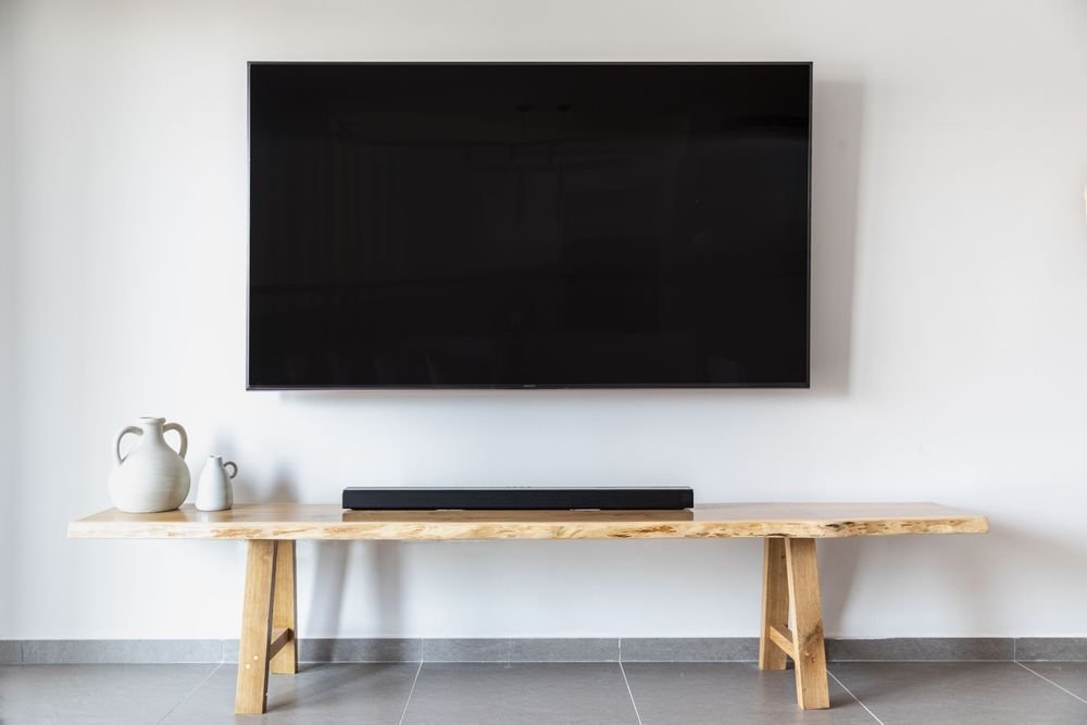 Flat-screen TV mounted on a wall, running digital signage content reliably