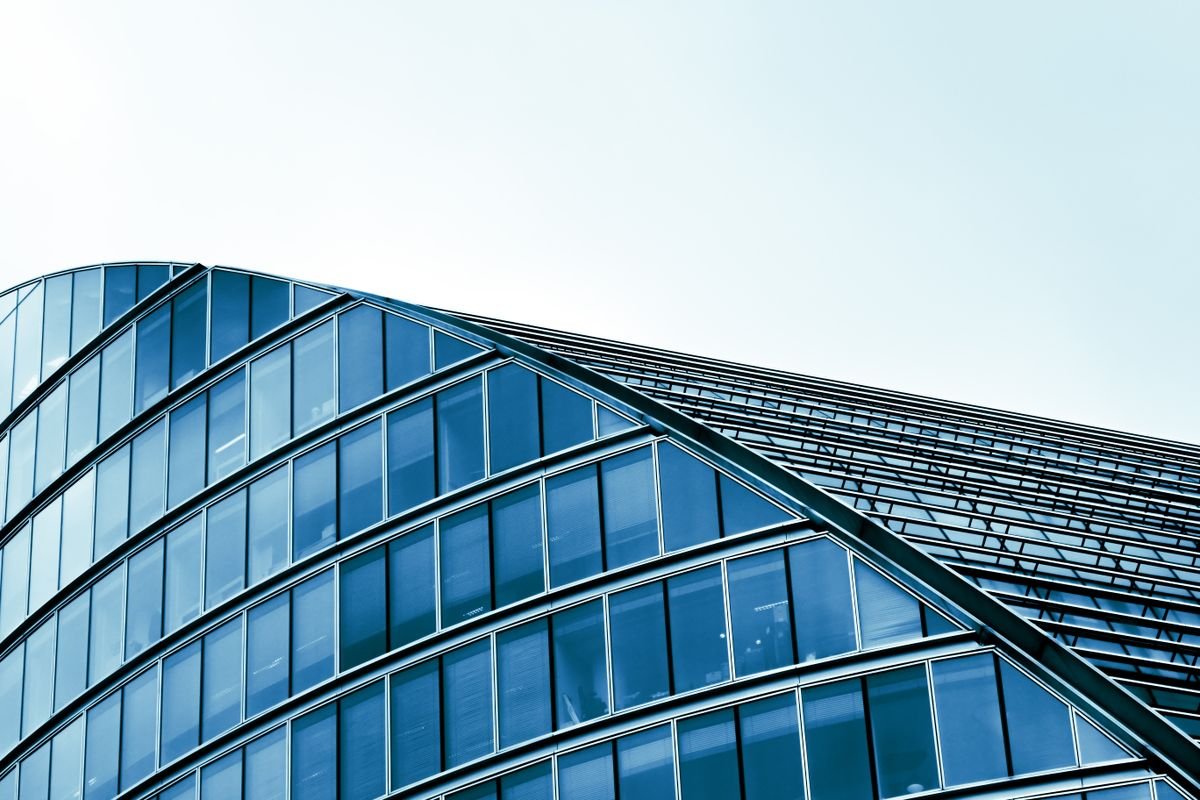 Modern glass-fronted commercial building, representing a multi-location retail or franchise network