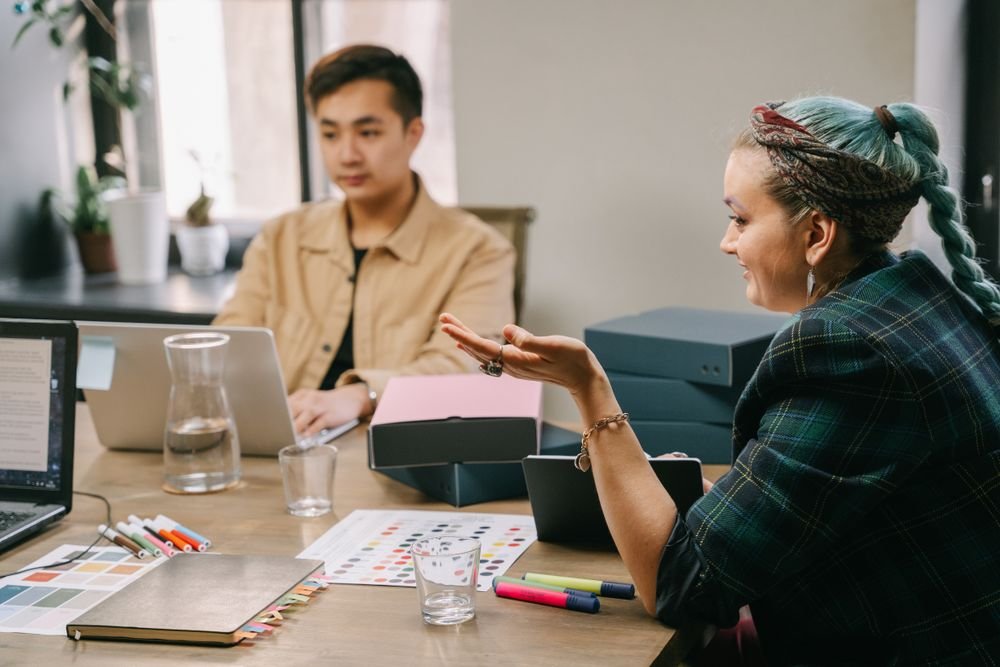 Marketing agency team collaborating around a table, planning a branded client offering